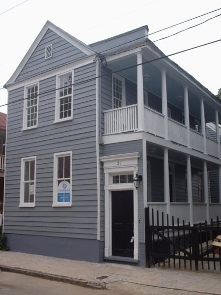The same view after restoration, with rebuilt double-stacked side porches.