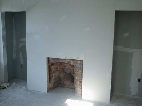 Second fireplace stripped back to original brick during reconstruction.