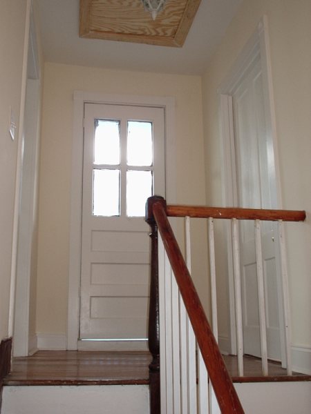 The same rear door finished, with restored four-light transom.